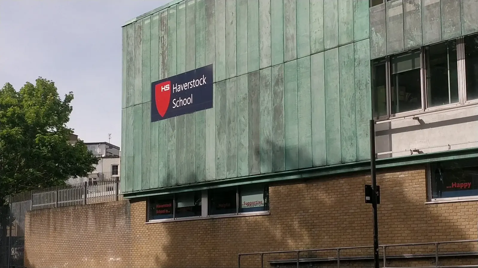 Haverstock School entrance with branded signage in London, host venue for Super Mario Salsa socials