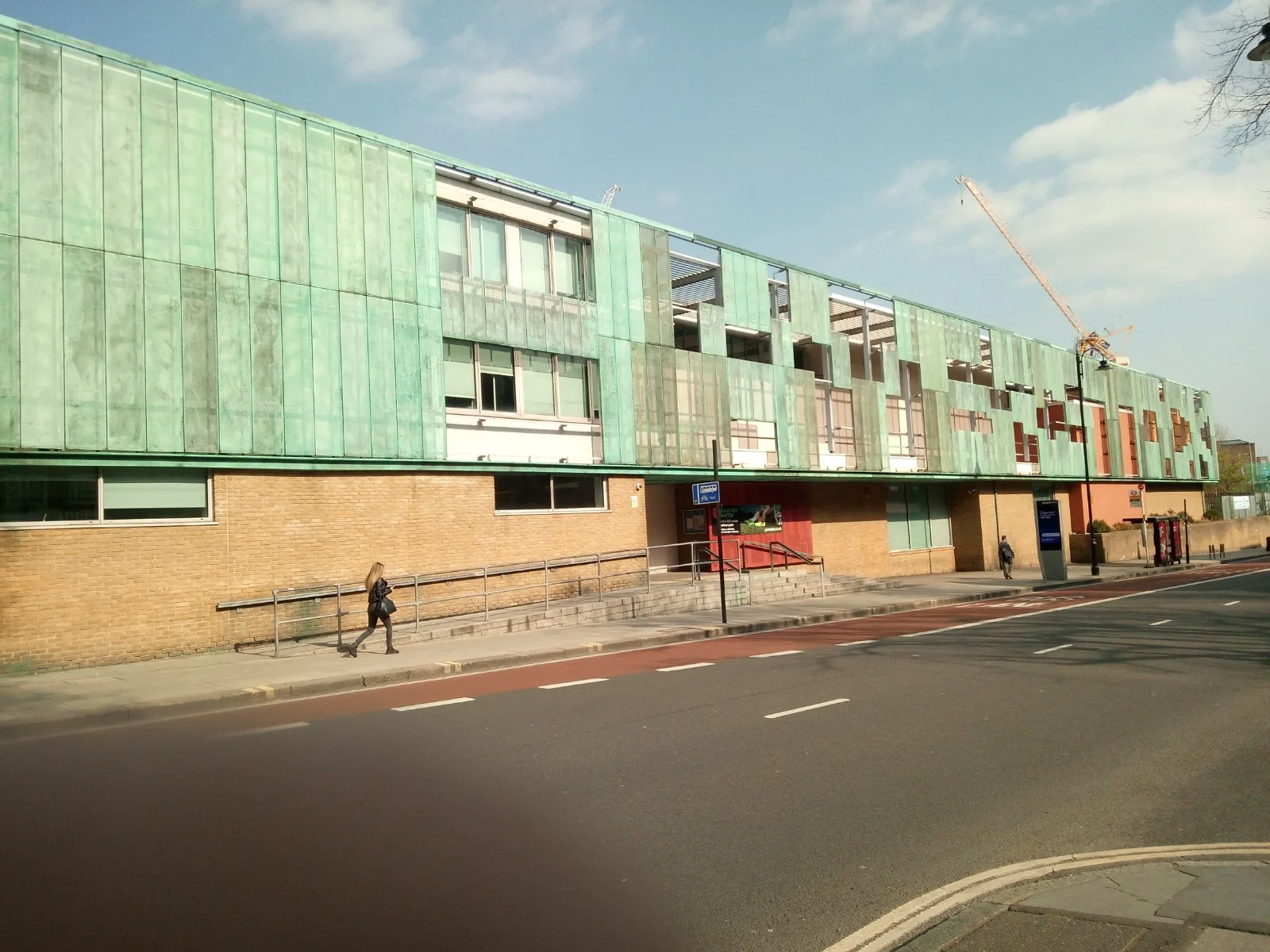 Wide exterior view of Haverstock School's green copper-clad building in Camden, London