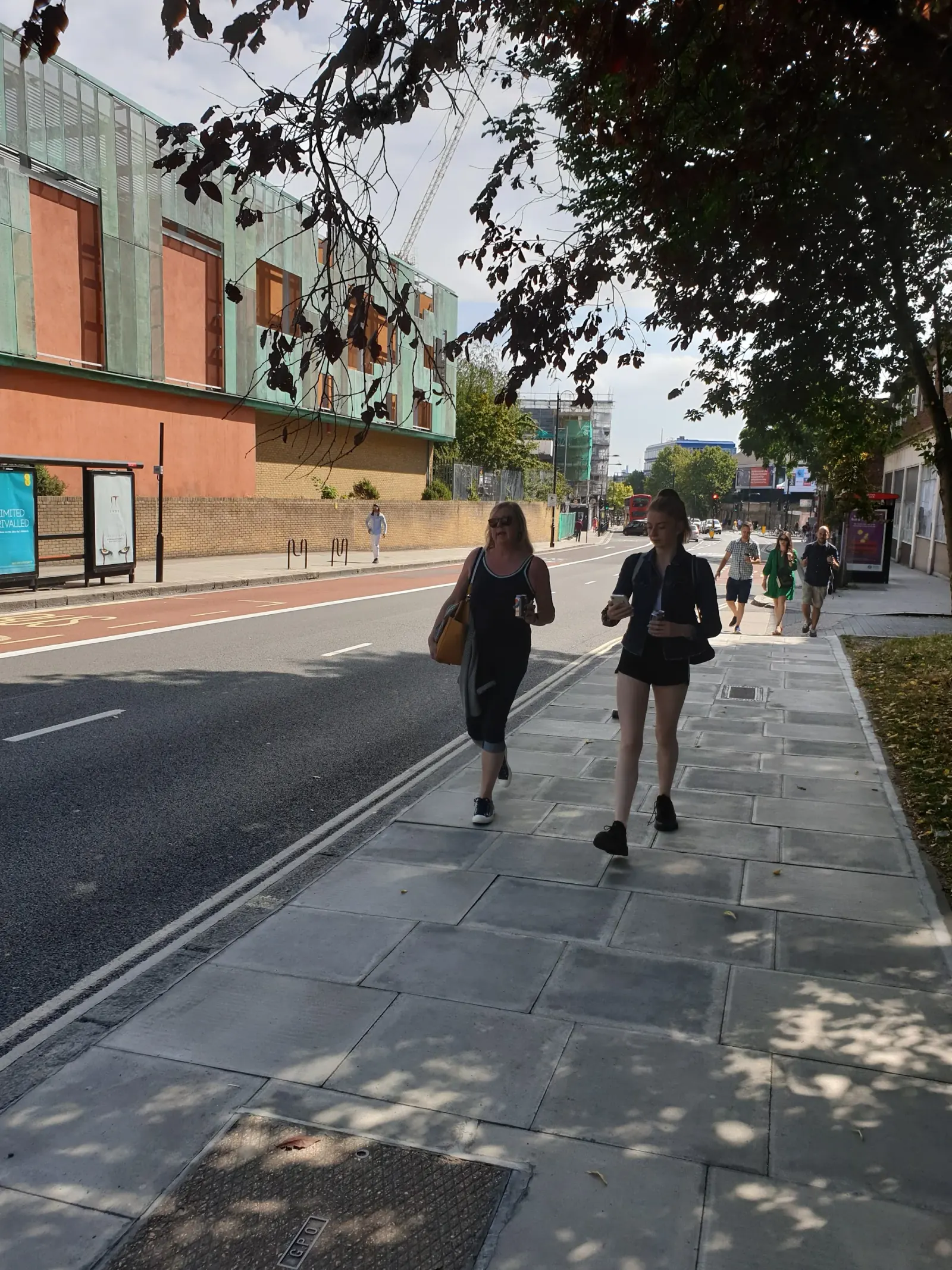Street approach to Haverstock School in Camden, London with the venue's distinctive green facade in view
