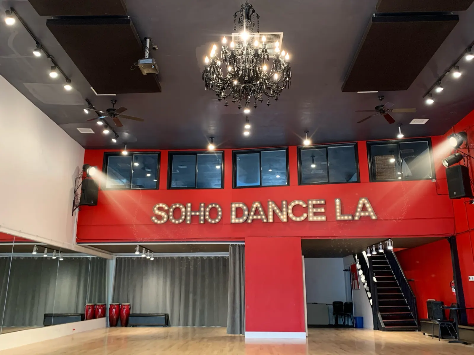 Lit Soho Dance LA marquee letters above the mirrored dance floor at Soho Studios Sherman Oaks