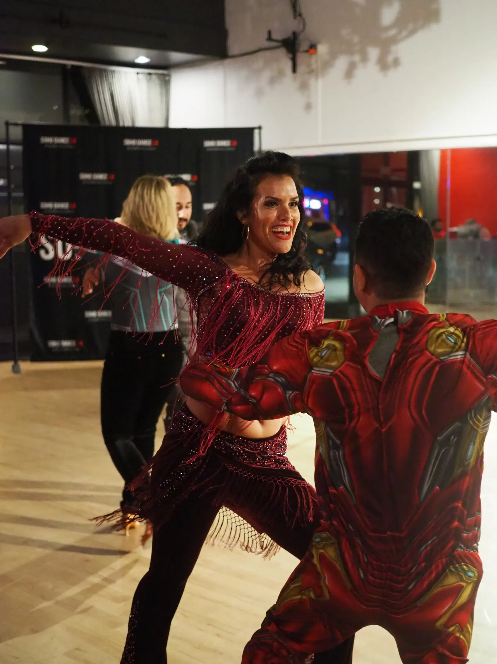 Two dancers performing on the studio floor in front of the Soho Dance LA backdrop in Los Angeles