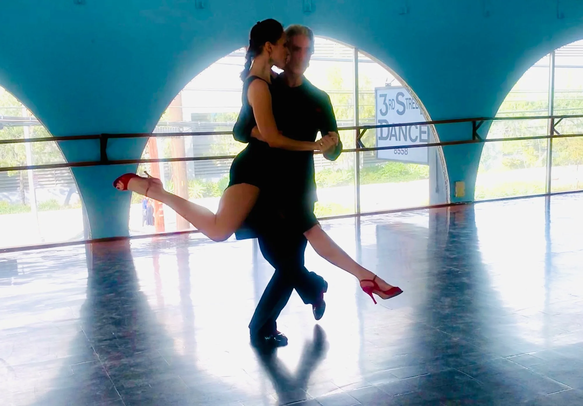 Couple dancing salsa on the studio floor at Dance Street California Pasadena