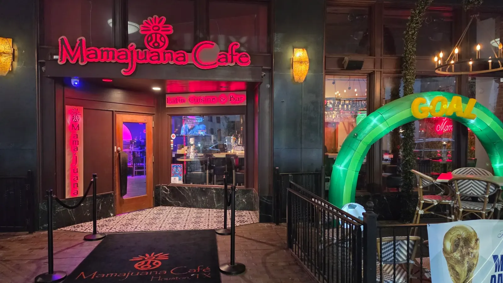 Mamajuana Cafe entrance with Latin Cuisine and Bar signage and logo mat, Houston