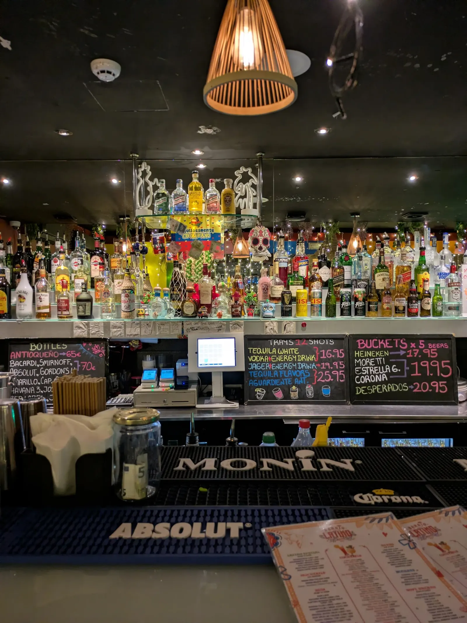 Well-stocked bar with skull decorations and cocktail menu at Barrio Latino Malta