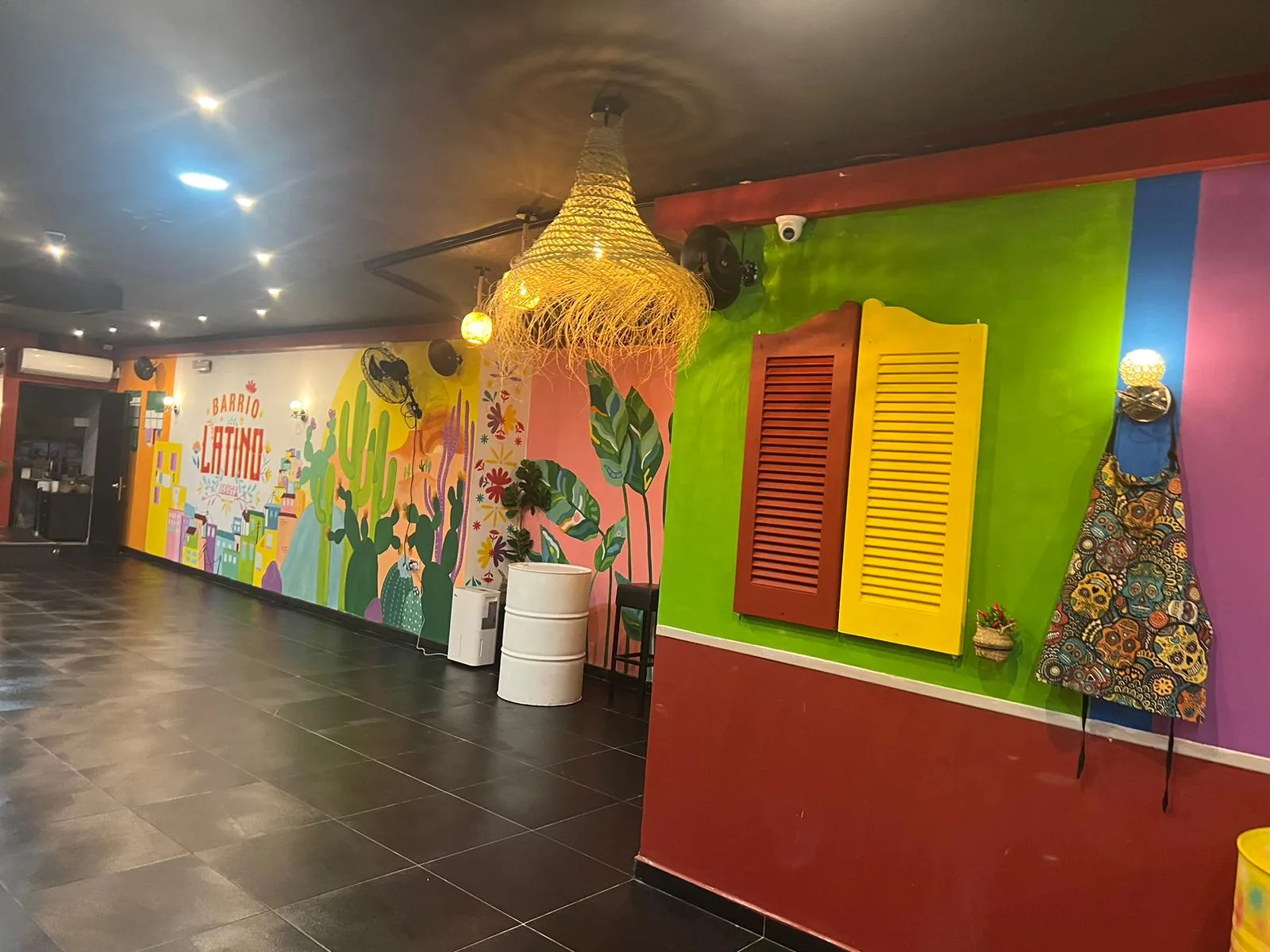 Colorful interior with Barrio Latino mural and rattan lamp at Barrio Latino Malta, Sliema