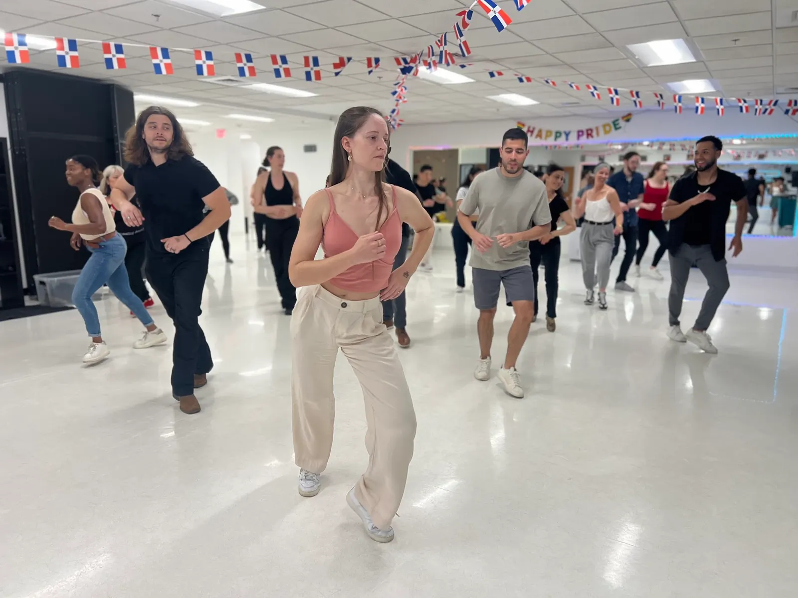 Group of dancers practising footwork in the bright studio room at J&L Dance Studio in Boston