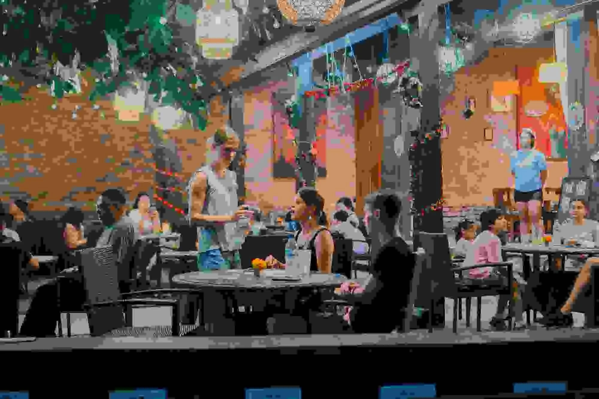 Lively crowd seated under hanging lanterns at Mezza Mediterranean Cuisine in Bali