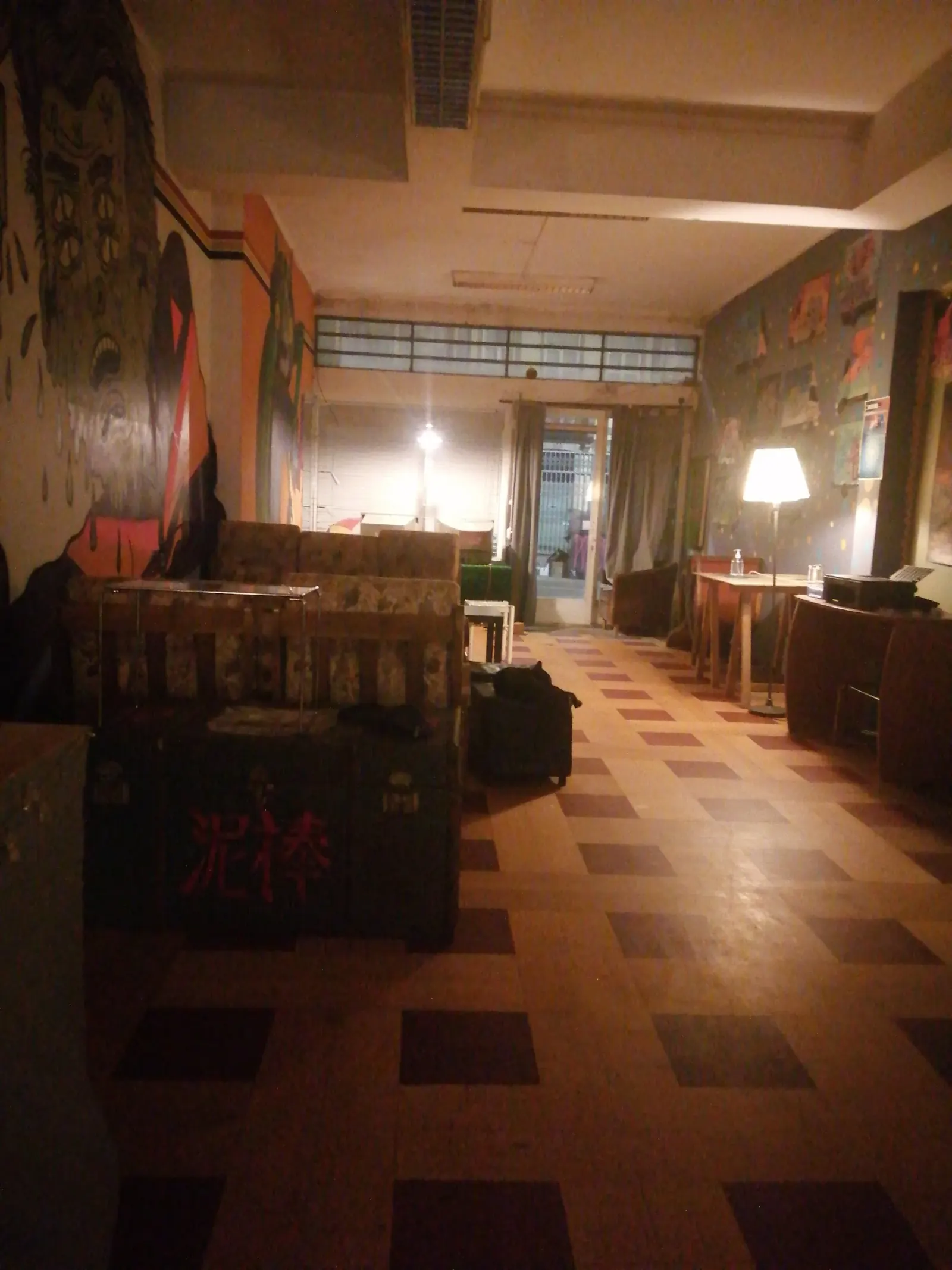 Dark venue interior with colorful murals at Espaço Cultural Jubilant Porto Portugal