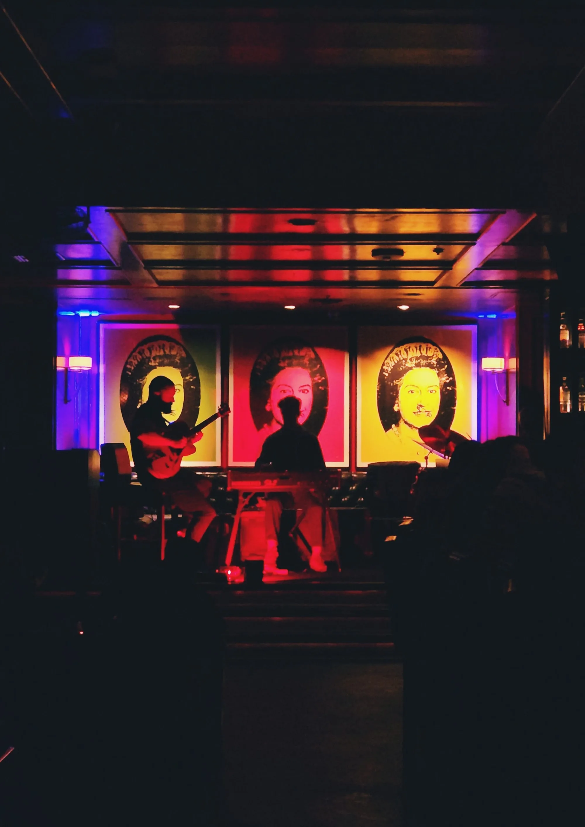 Live band performance on stage with pop-art backdrops at The Continental Club LA