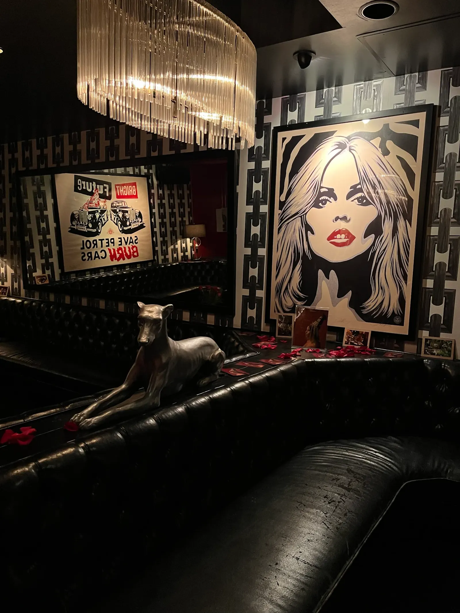 Dark lounge corner with vintage art and leather seating at The Continental Club LA