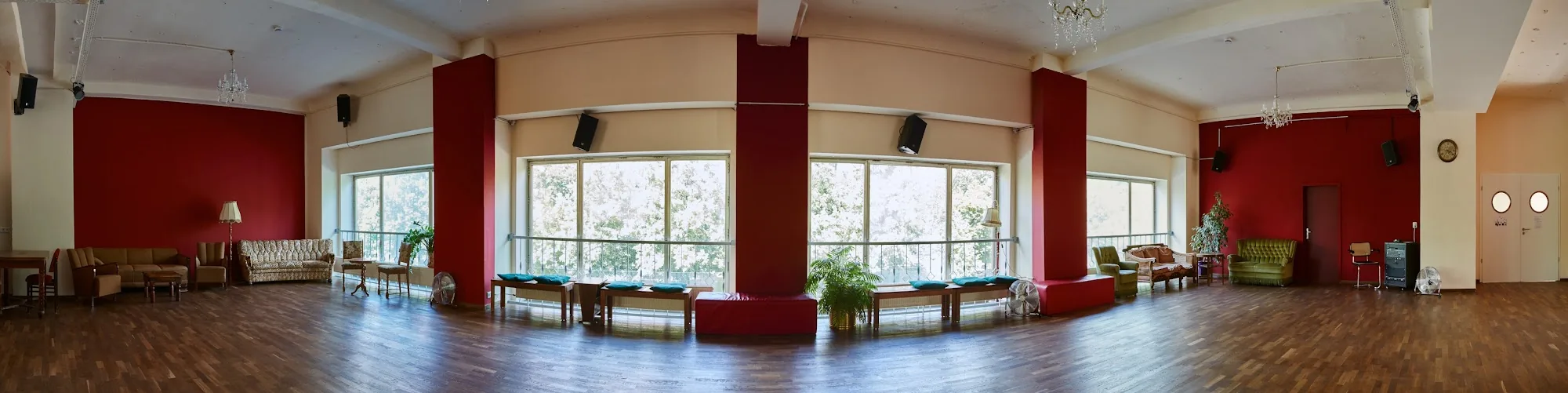 Panoramic view of Baileo Tanzstudio dance hall with red walls and chandeliers, Leipzig