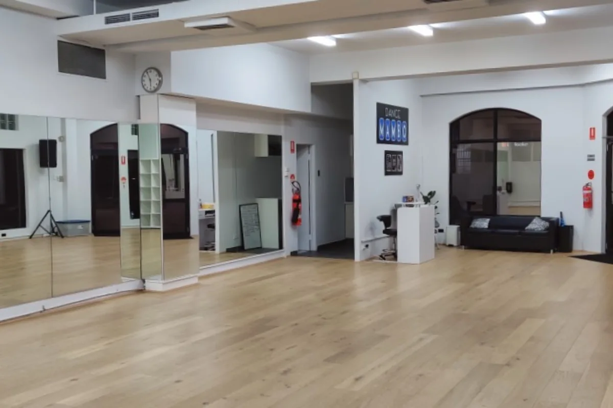 Dance studio interior with wooden floor and mirrors at Dance Mambo Ultimo Sydney