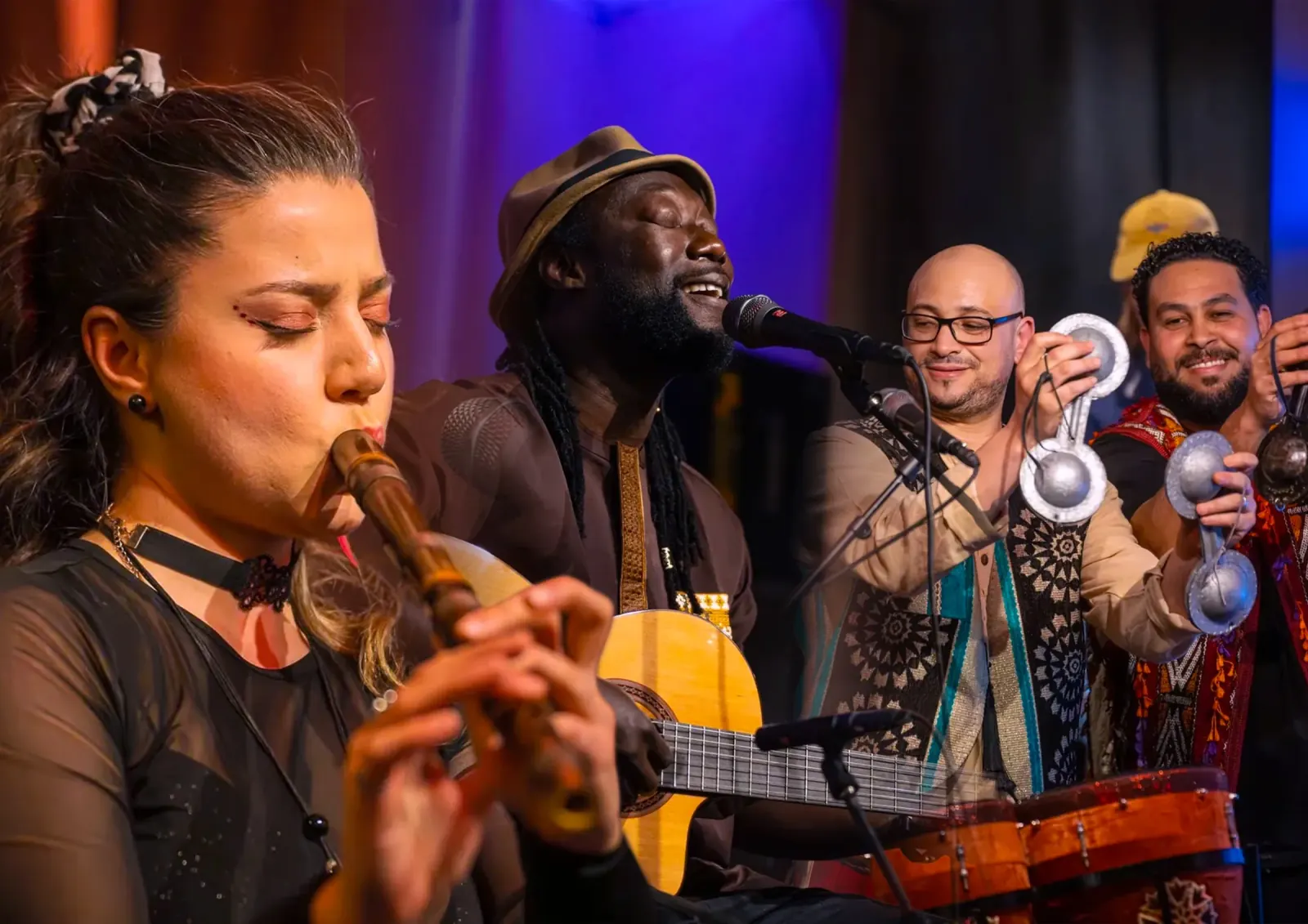 Live Latin band performing with flute, guitar and percussion on stage at Cafe Sor