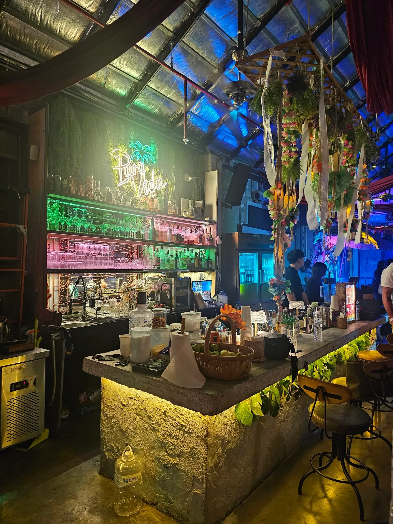 PuraVida Entertainment One Nimman Chiang Mai — bar with neon Pura Vida palm tree sign and colourful bottle shelves