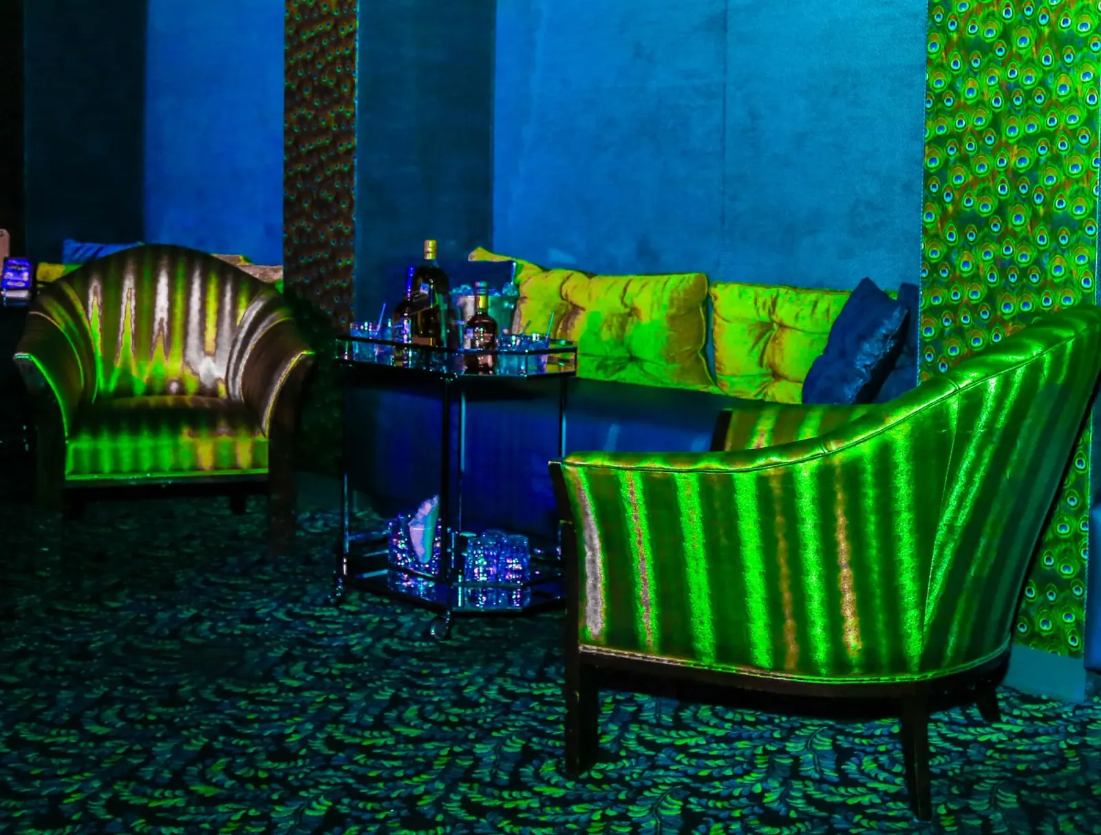 Green and blue lit lounge seating area at Club Tropicana nightclub, Houston