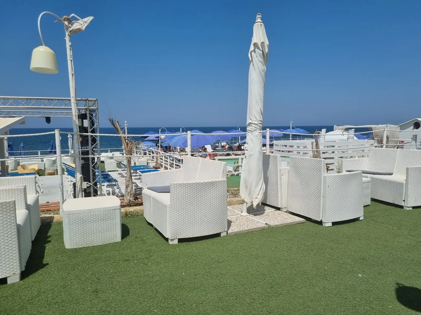 Lounge seating with stage truss and sea view at Sea Public in Aspra, Italy