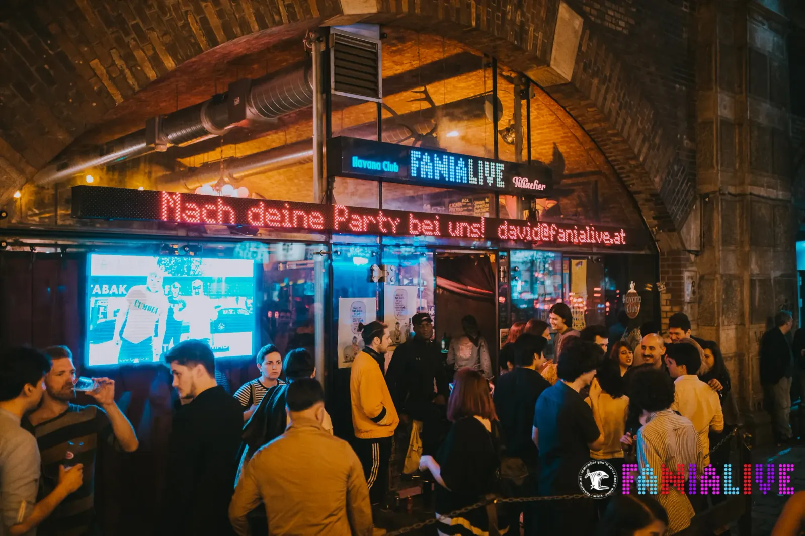 FANIALIVE exterior neon sign with crowd at entrance Vienna Austria salsa venue