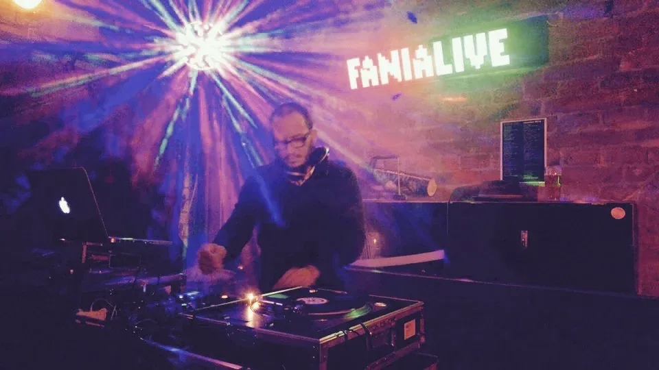 FANIALIVE DJ booth in Vienna with neon sign and colorful stage lights