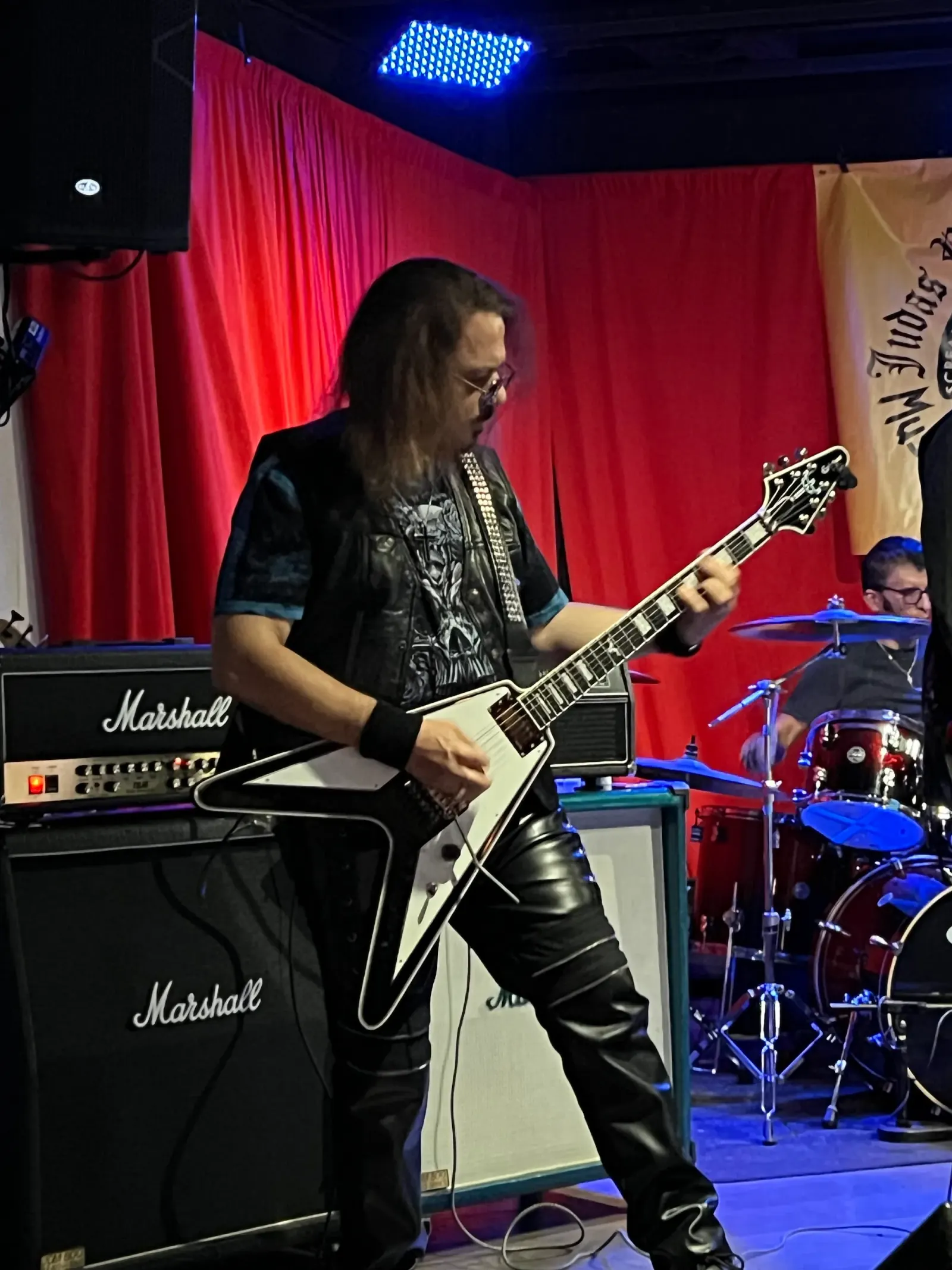 Guitarist performing live on the red-lit stage at The Mamba in Huntington Beach