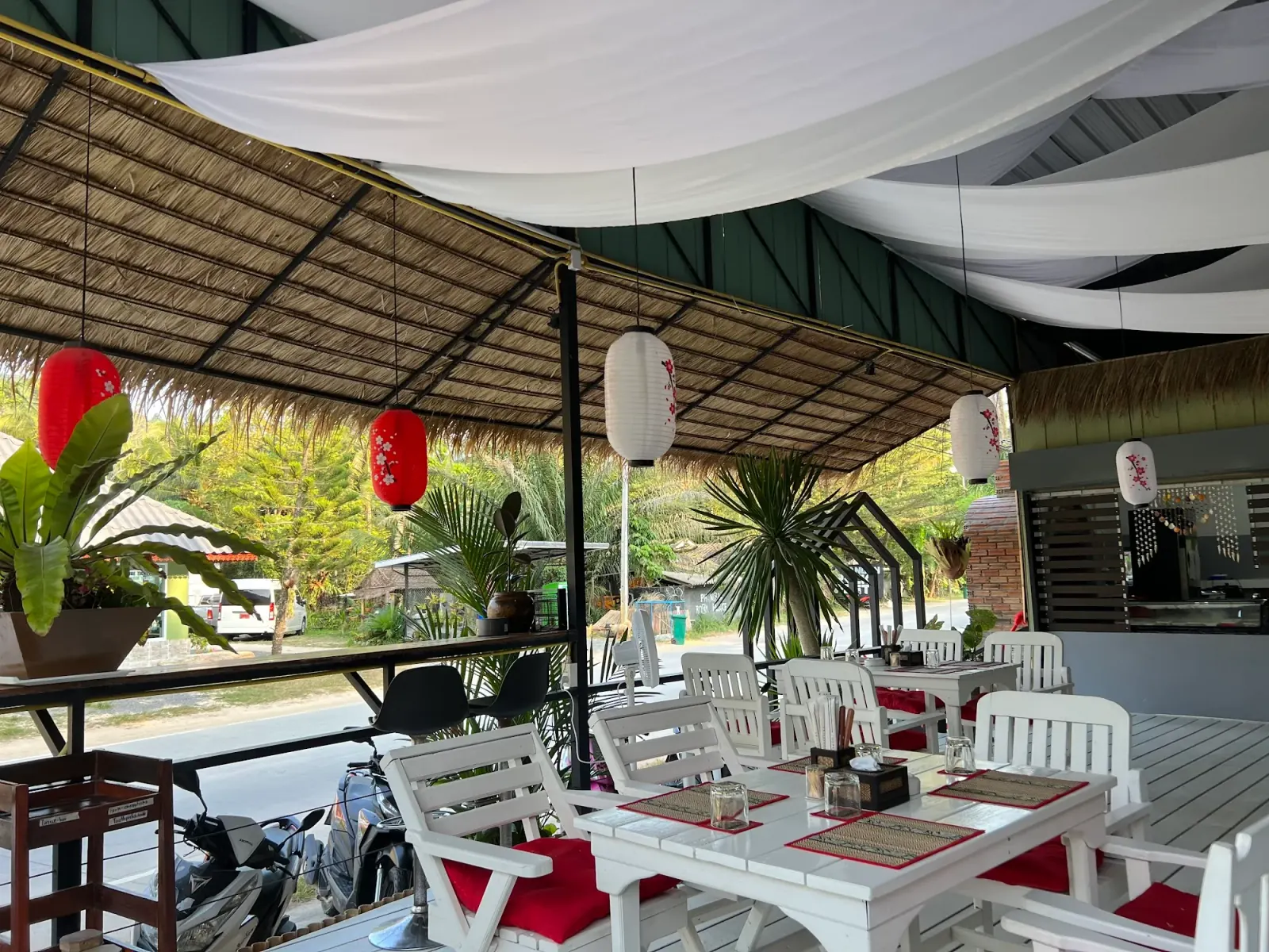 Thatched-roof open-air interior of Sushi Love restaurant and bar in Koh Phangan