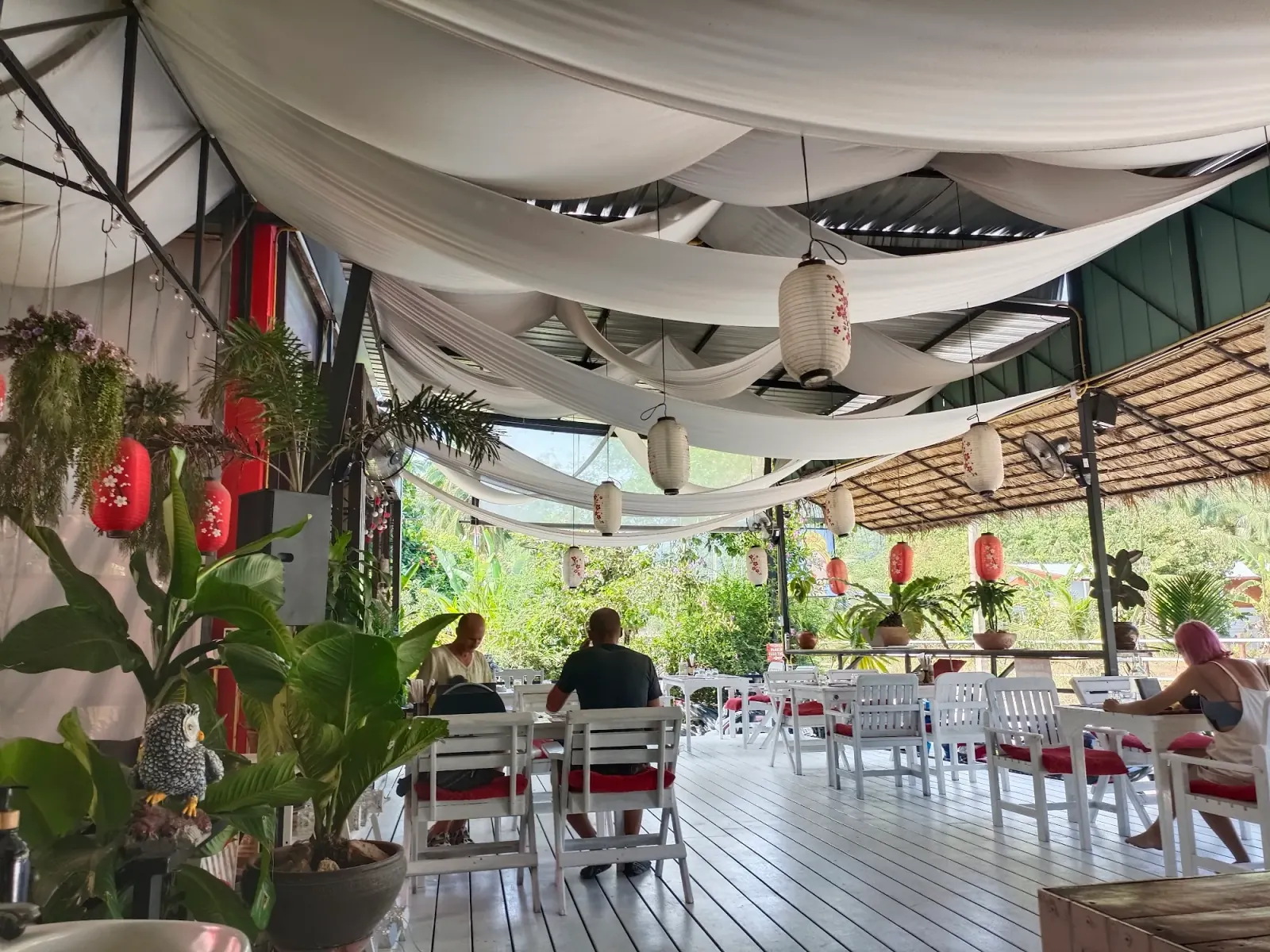 Guests relaxing at Sushi Love open-air venue with draped fabric ceiling in Koh Phangan