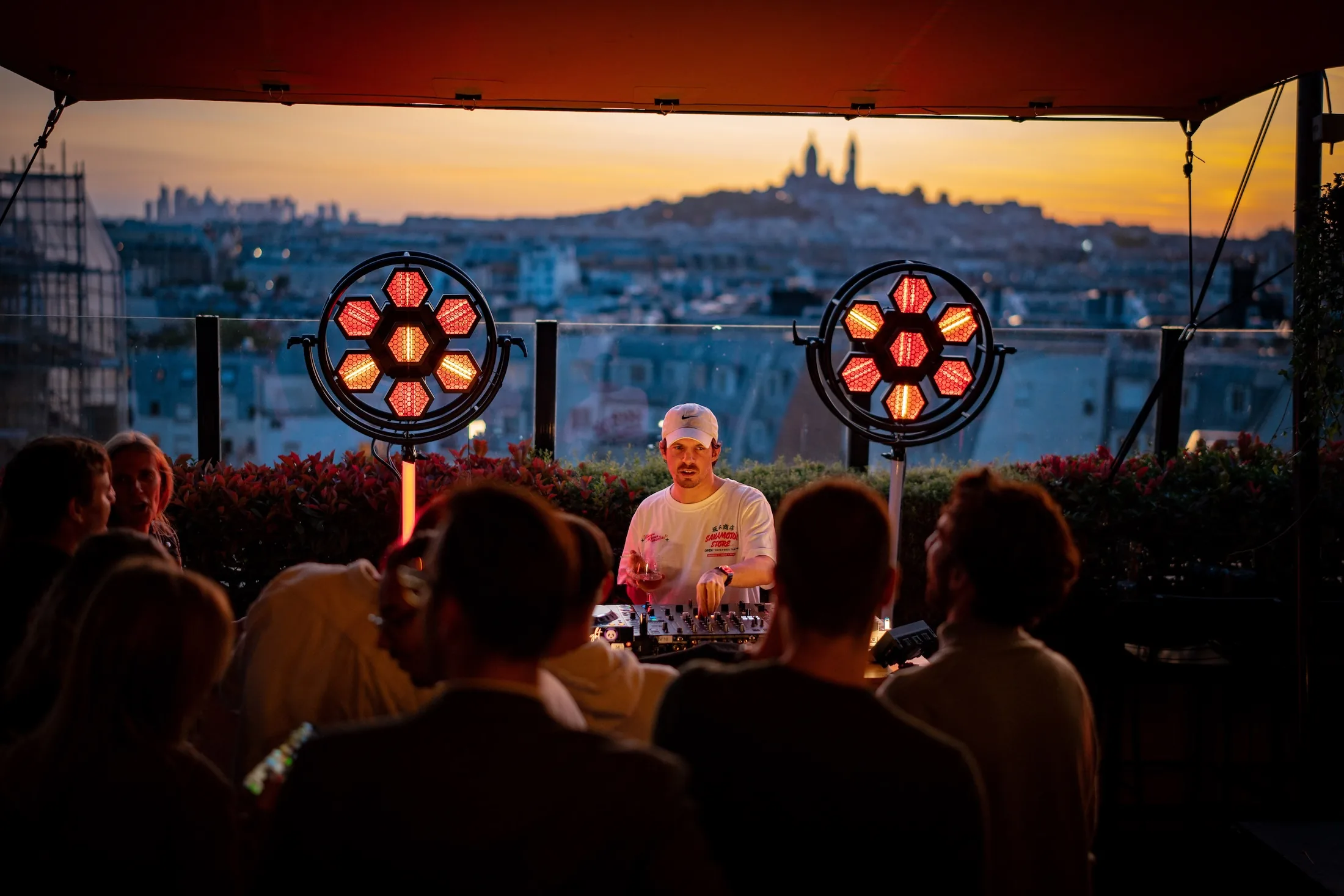 DJ set with crowd at sunset rooftop party at Generator Hotel