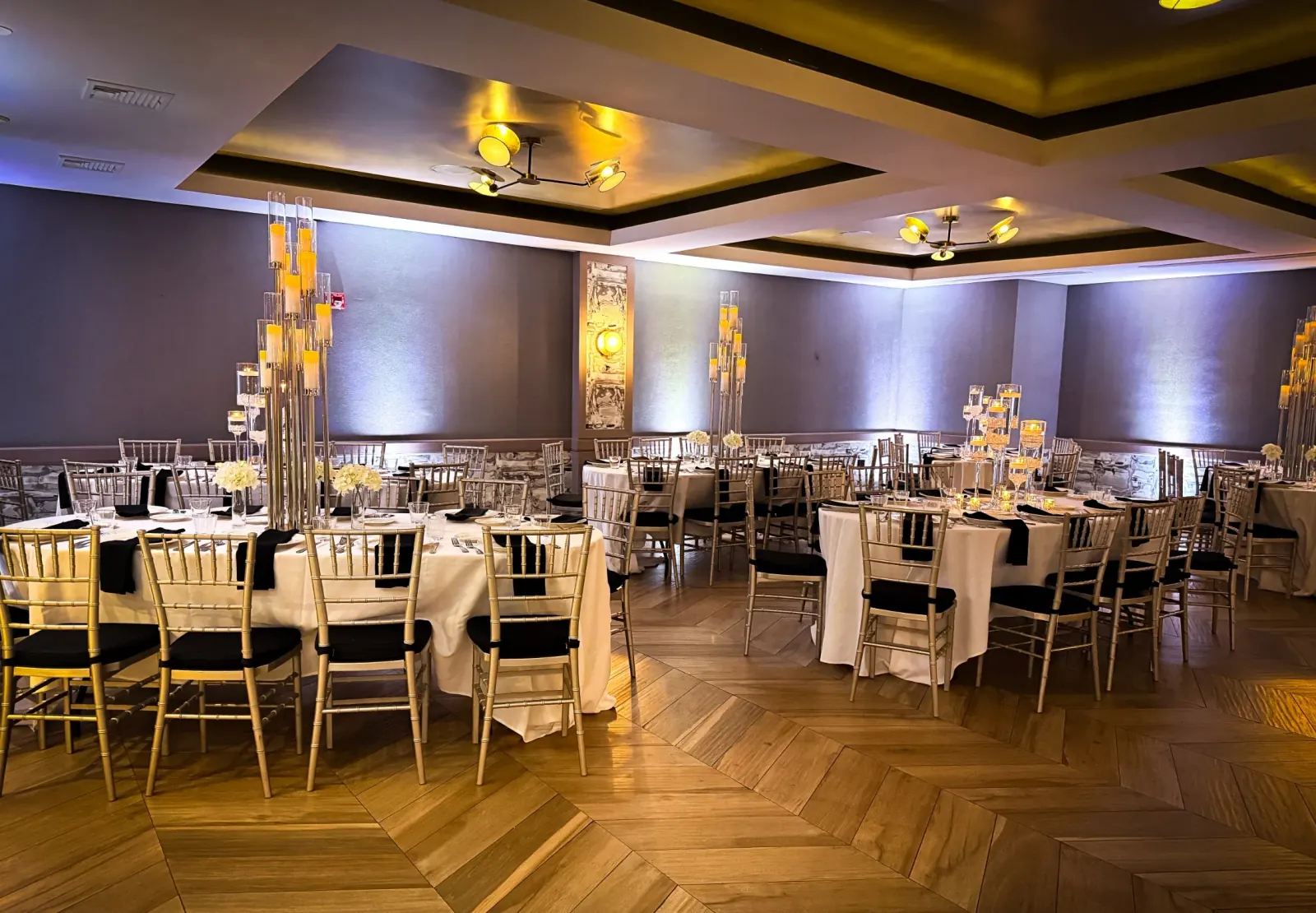 Elegant event room with chandeliers and chevron floor at K. Pacho New York