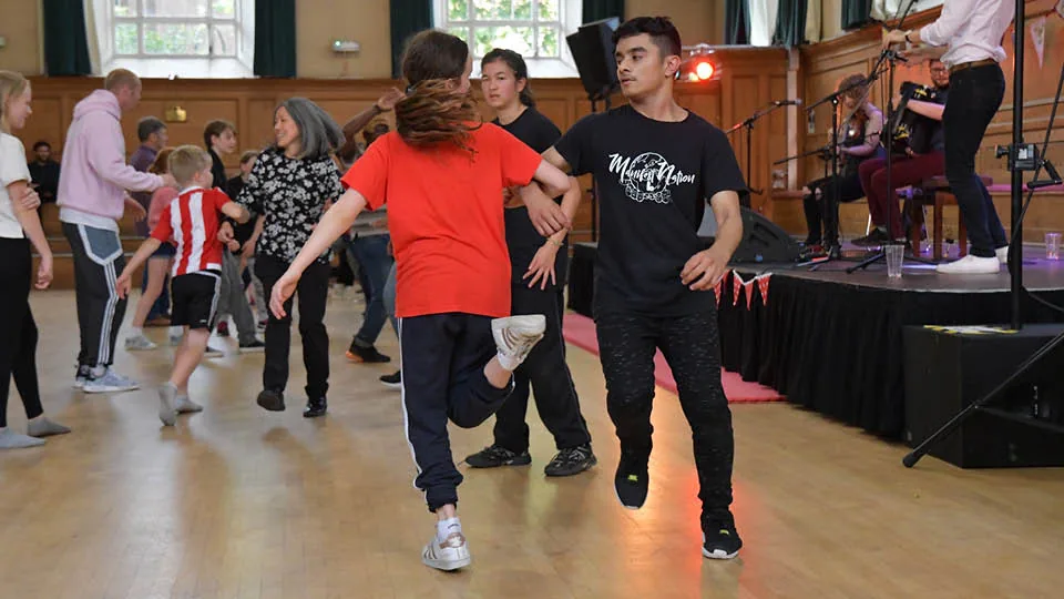 Dancers on the wooden dance floor with live band at Cecil Sharp House, London