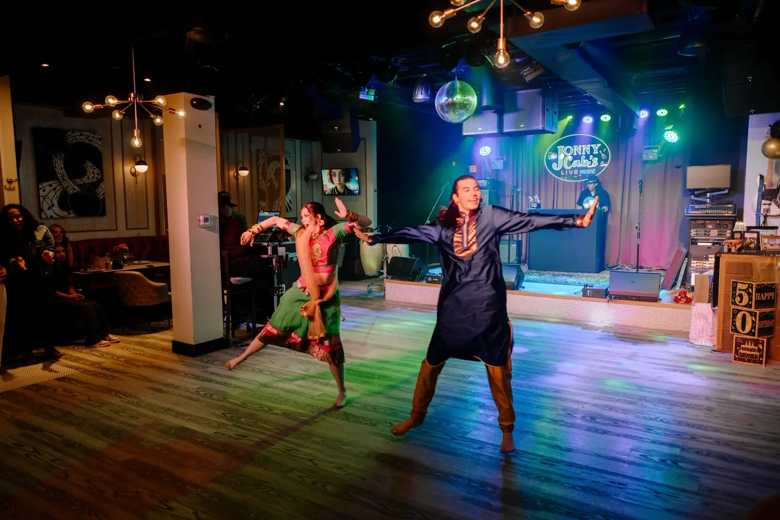 Dancers performing on the Jonny Cab's dance floor under club lights