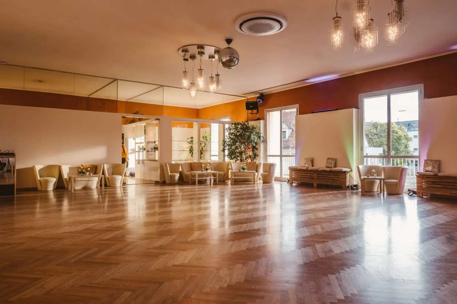 Large polished dance floor with mirrors and disco ball at Tanzschule Conny and Dado Graz