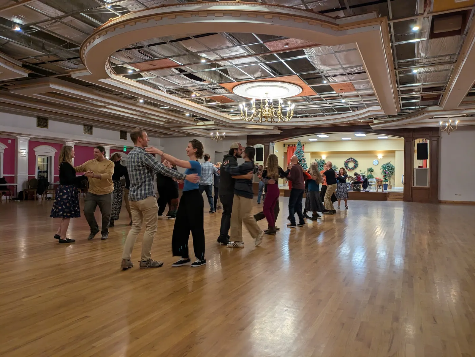 Couples dancing under the chandelier on the wide ballroom floor at The Avalon Ballroom