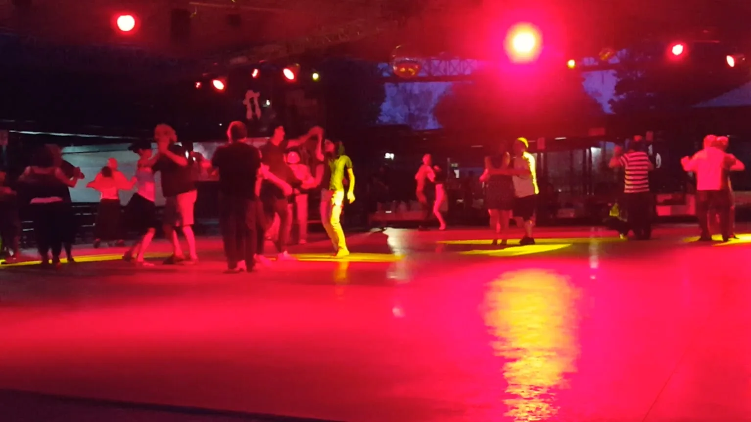 Penelope Beach Torino — dancers on outdoor dance floor under stage lighting at night