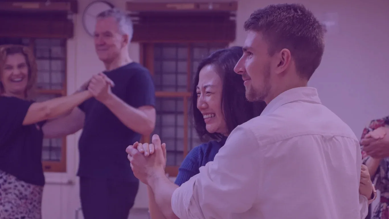 Couples dancing together and smiling during a Latin dance class at Rio Rhythmics Latin Dance Academy in Brisbane