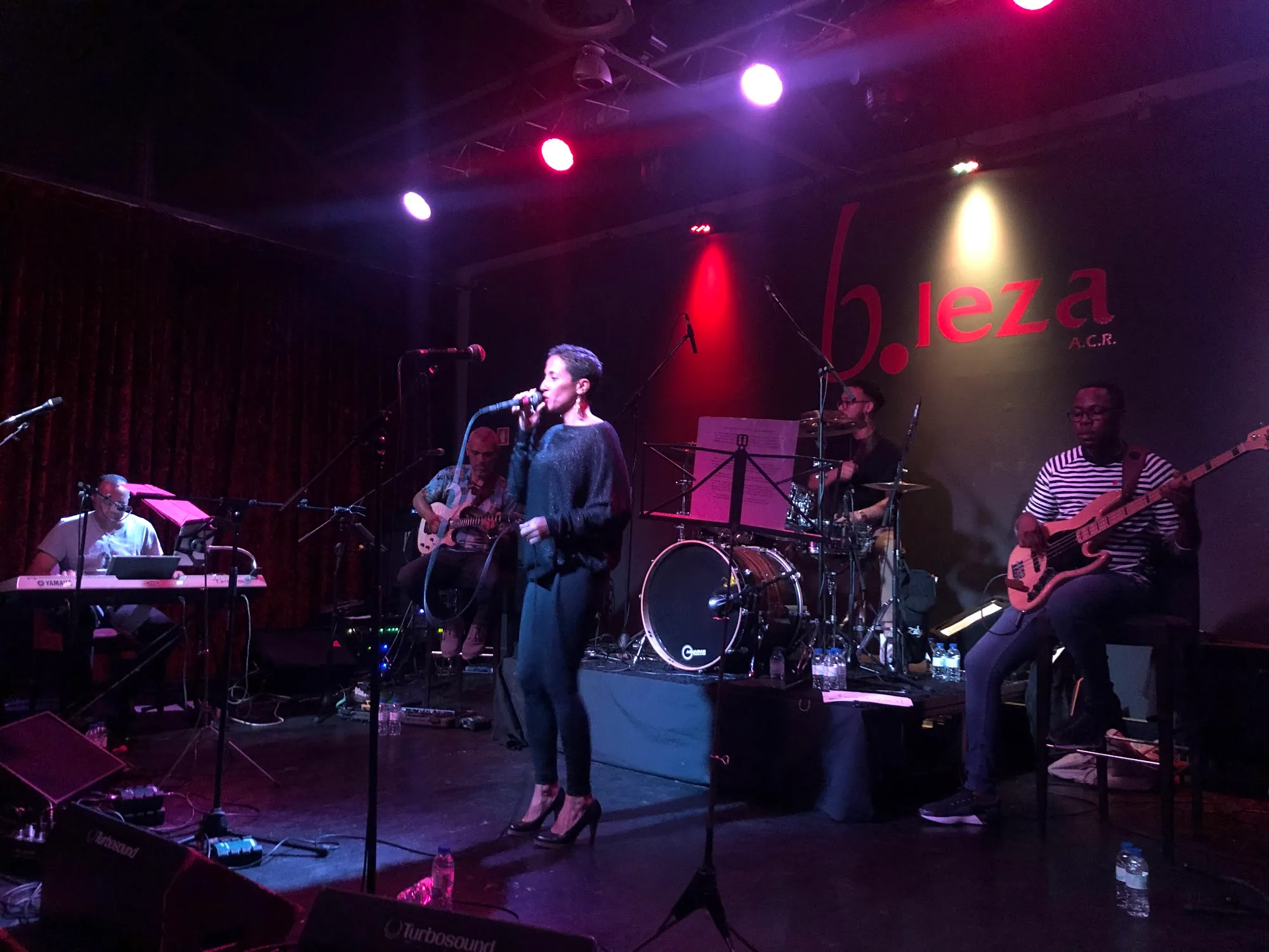 B.Leza live band on stage with logo
