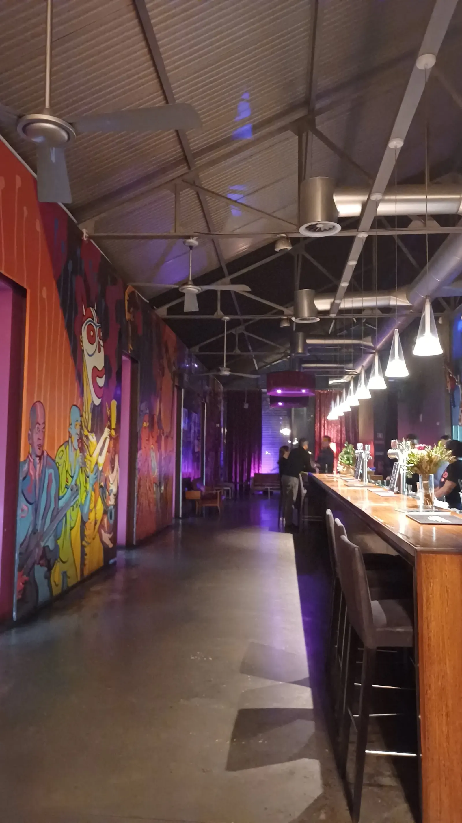 B.Leza venue interior with colorful murals and bar area