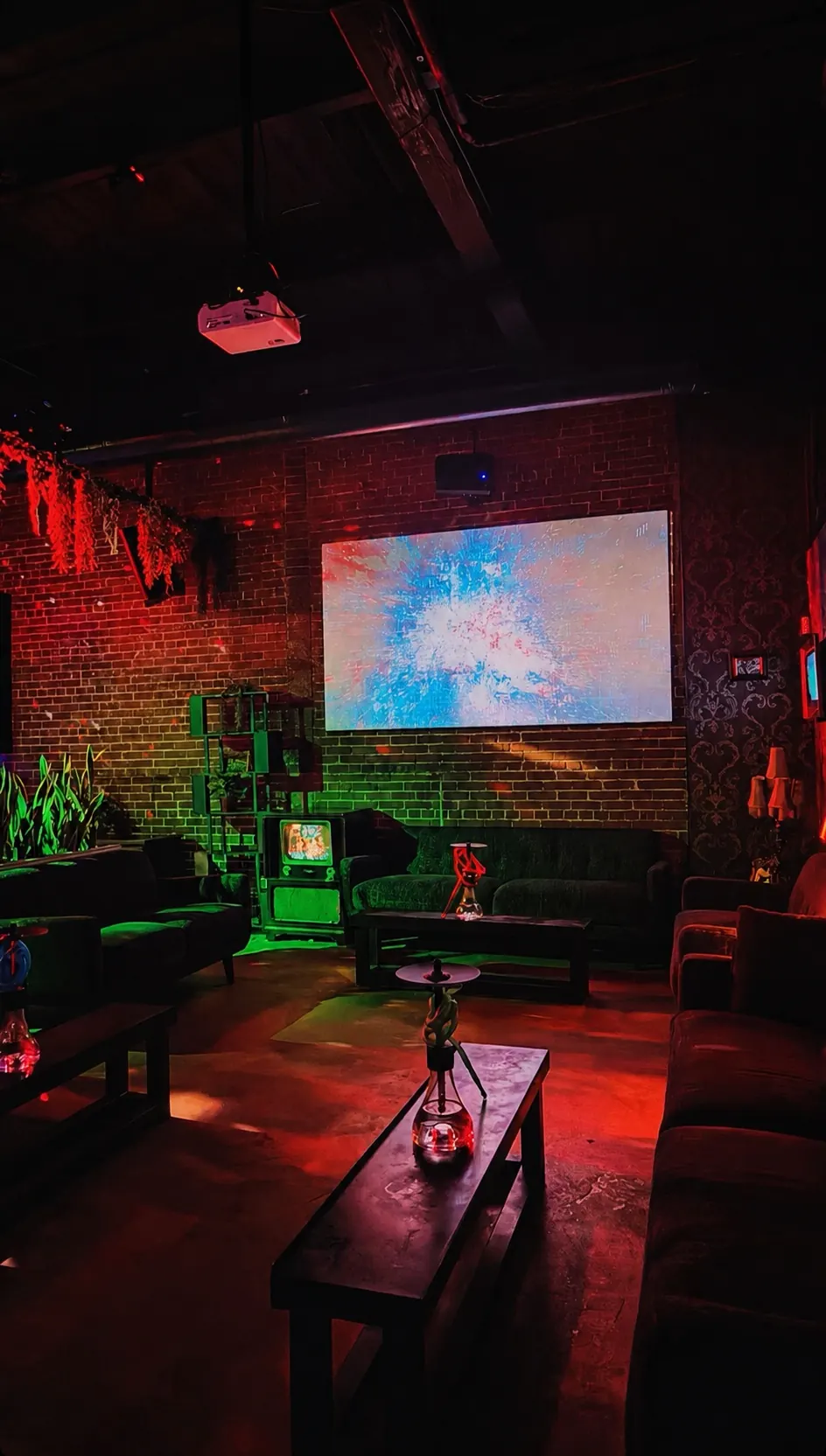 Lounge sofas and projection screen in the back room of Distrito Federal in Houston