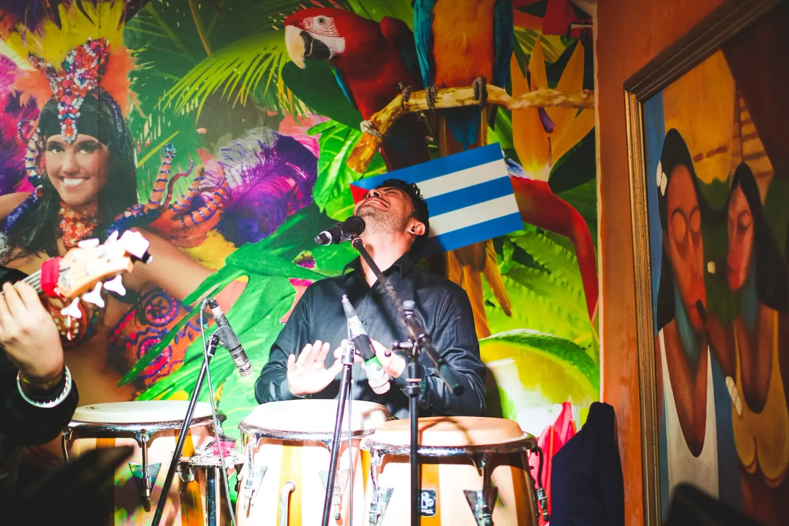 Live conga musician performing at Cuba Libre Singapore with Cuban murals