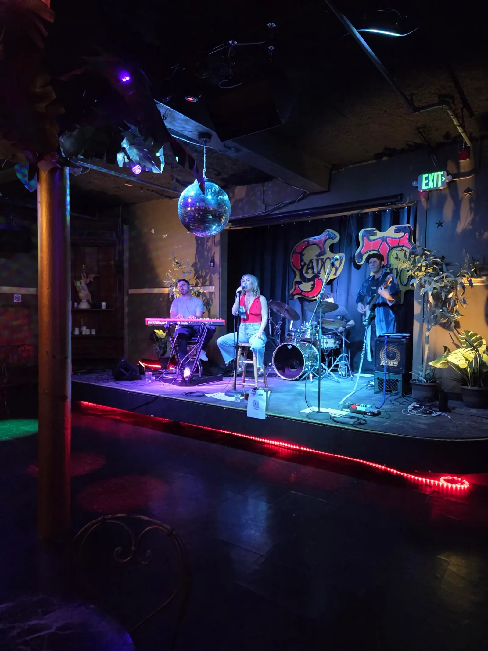 Live band performing on stage with disco ball and dance floor at Savoy Tivoli in San Francisco