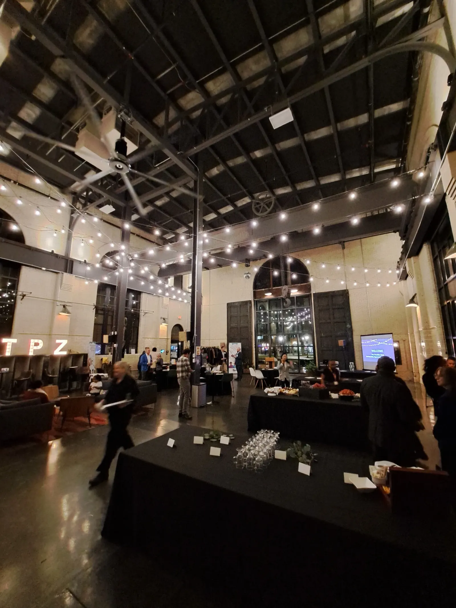 Evening event at The Substation Boston with string lights, crowd and TPZ neon — large industrial dance hall atmosphere