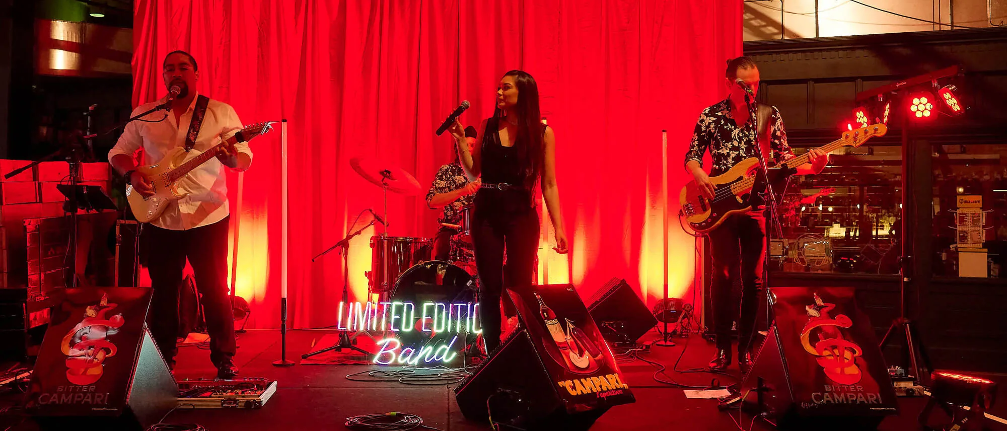 Live band performing on stage with red lighting at Hay St Market in Sydney