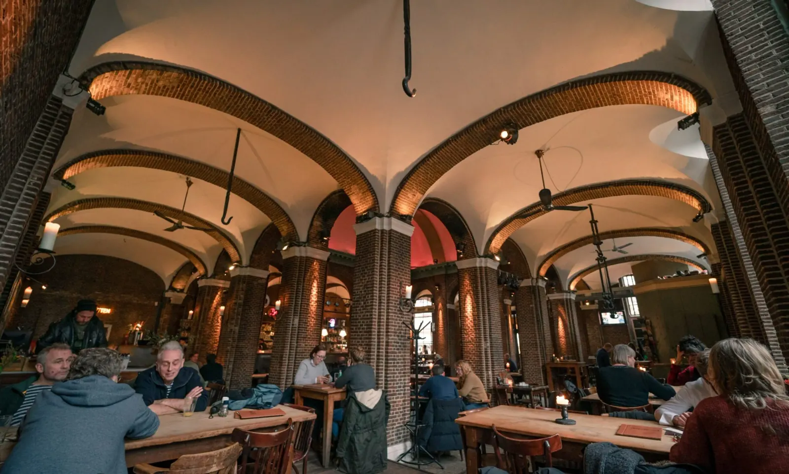 Historic hall interior of Stadscafe de Boterwaag with guests