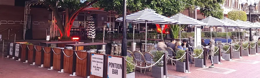 Pontoon Bar exterior terrace with branded signage in Sydney's Darling Harbour