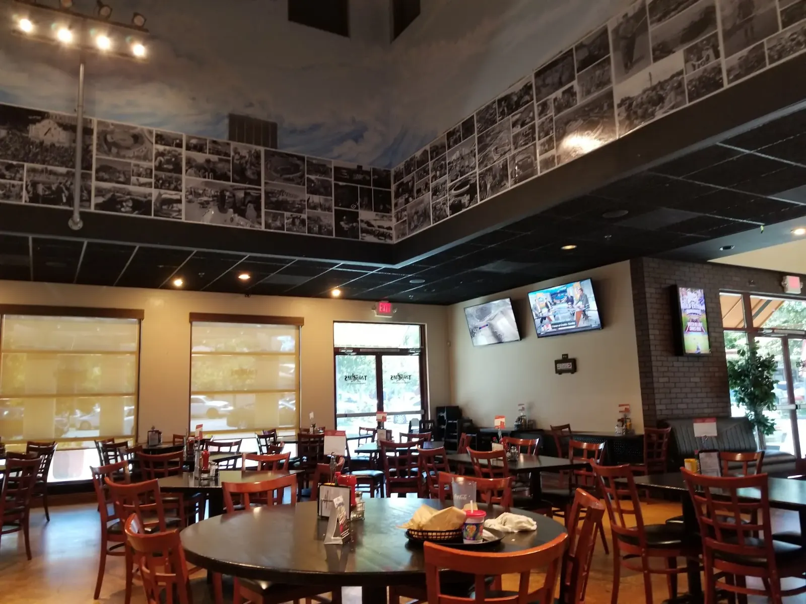 Dining room interior with tables and photo-mural walls at Tailgaters Sports Bar, Antioch
