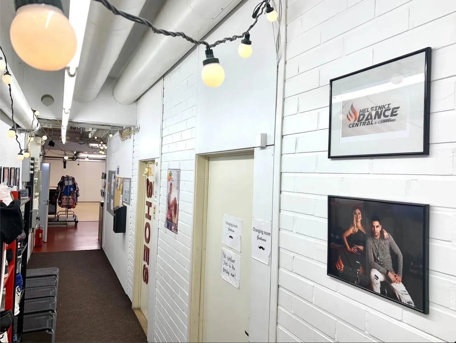 Hallway with branded Helsinki Dance Central signage and string lights inside the Helsinki venue
