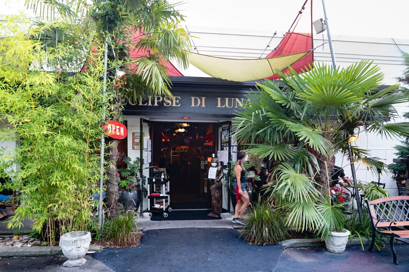 Entrance of Eclipse di Luna in Atlanta with the venue name above the open door and palms outside