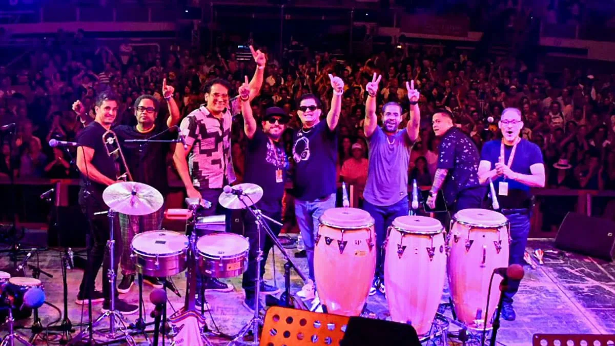 Live Latin band performing on stage at Gonzalez y Gonzalez in New York with percussion instruments and an energetic crowd