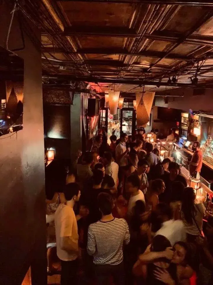 Elevated view of a crowded Latin dance night at Solas Bar in New York, with dancers filling the atmospheric underground venue