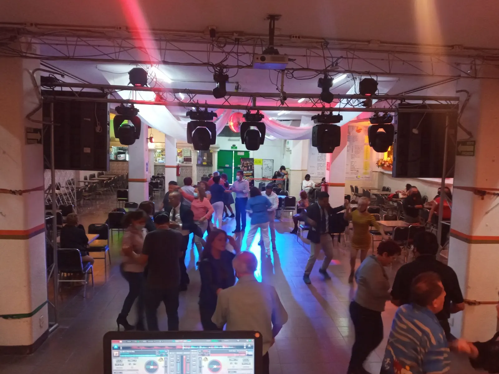 Dancers on the floor under moving stage lights at Salón Candela, Mexico City