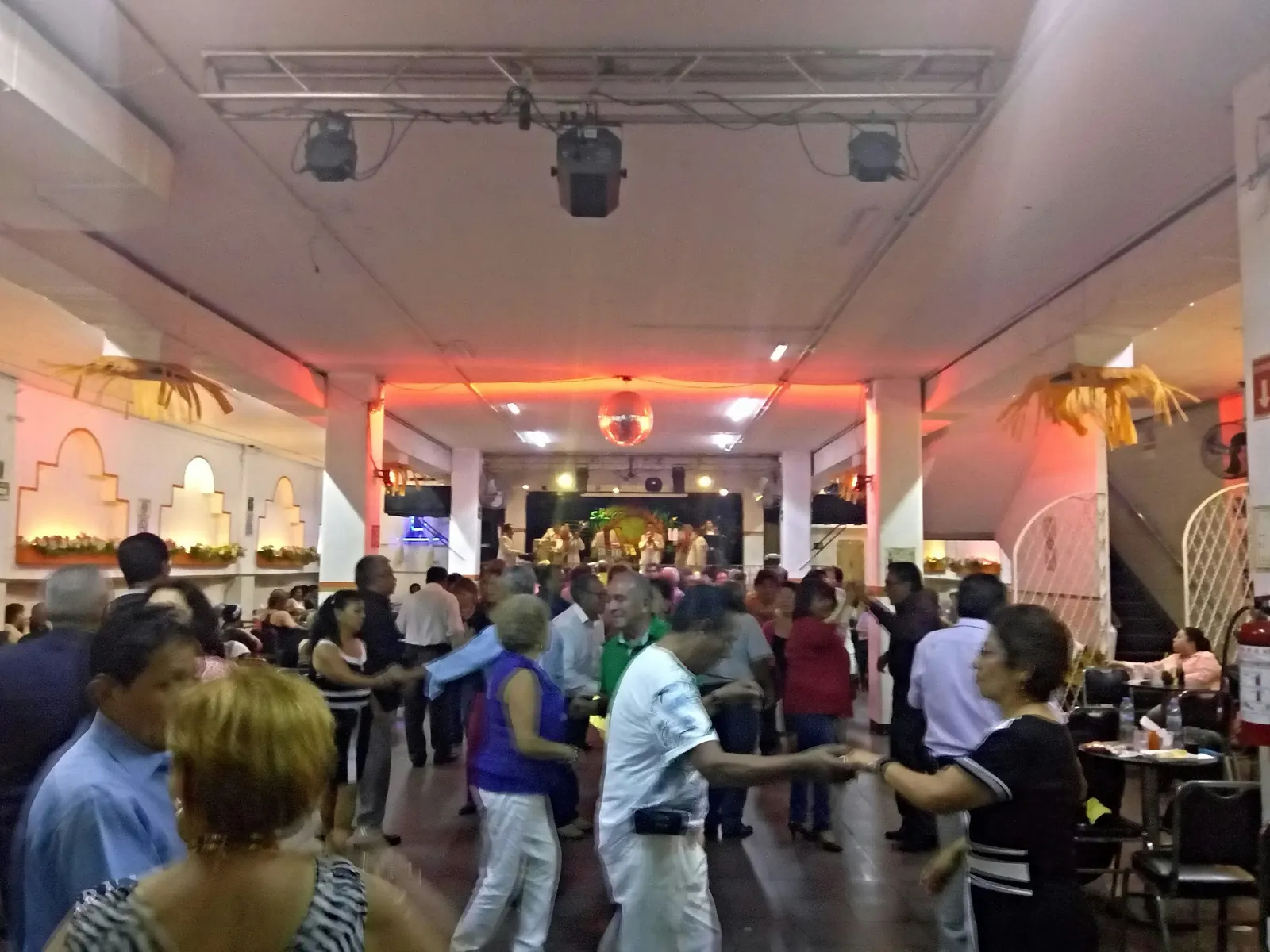 Couples social dancing with a live band on stage at Salón Candela, Mexico City