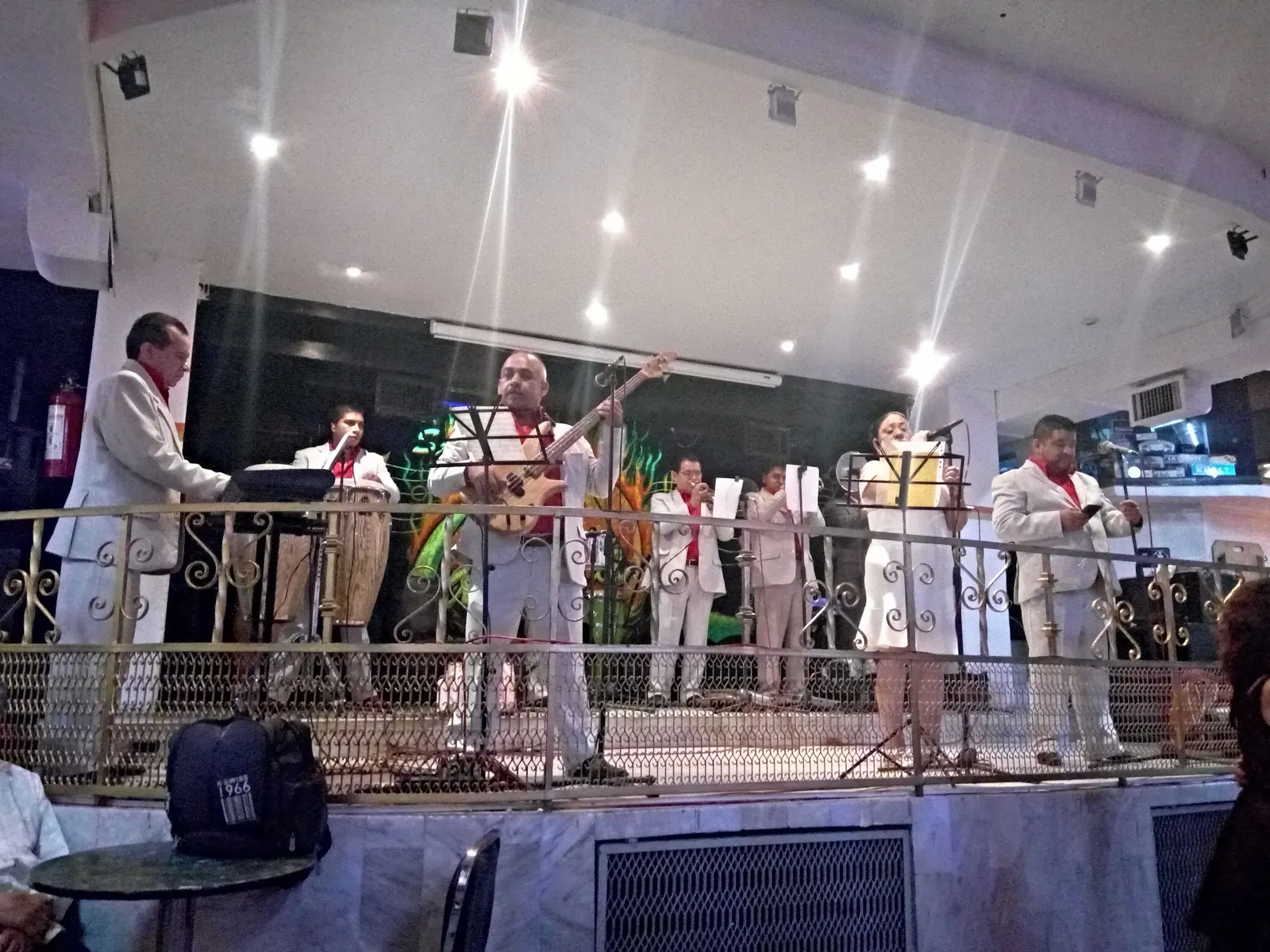 Live band in white suits performing on the stage at Salón Candela, Mexico City